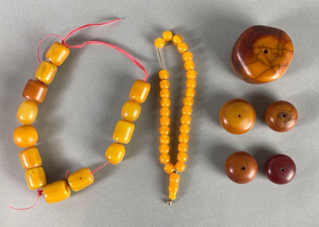 Group of Yellow and Red/Brown Bakelite Beads: Largest measures 2 1/2 x 2 1/2 x 1 1/2 inches.