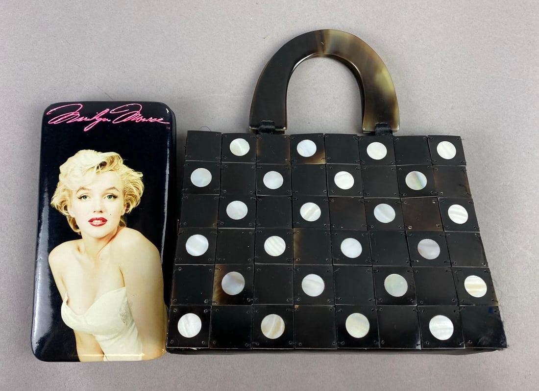 Group of 2 Retro Themed Purses: Includes Marilyn Monroe Clutch Purse and Mad Bags Horn tile bag. Largest measures H 5 3/4 x W 2 1/2 x L 7 3/4 inches.