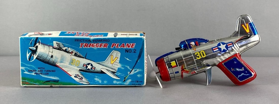 Vintage Nomura Tin-Litho Friction Powered Trigger Plane Toy: In working condition in original box, box measures 3 1/4 inches H x 8 inches W x 3 1/2 inches D