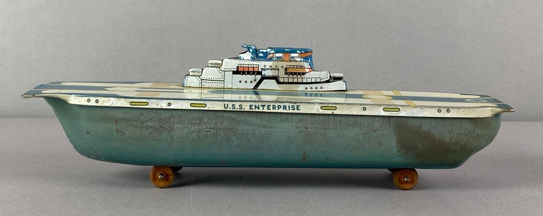Vintage Wyandotte Tin-Litho USS Enterprise Toy: Some scratches and paint wear, measures 3 1/2 inches H x 3 1/4 inches W x 12 inches D