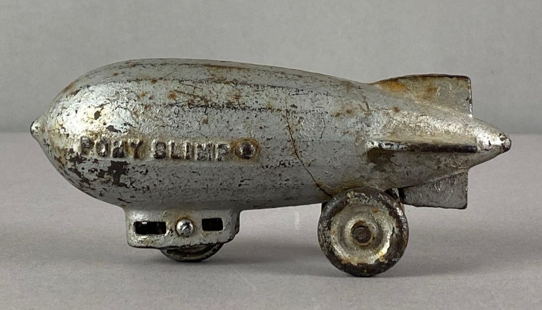 Vintage Kenton Cast Iron Pony Blimp Toy: rust and scratches throughout, measures 2 1/2 inches H x 2 inches W x 5 inches D