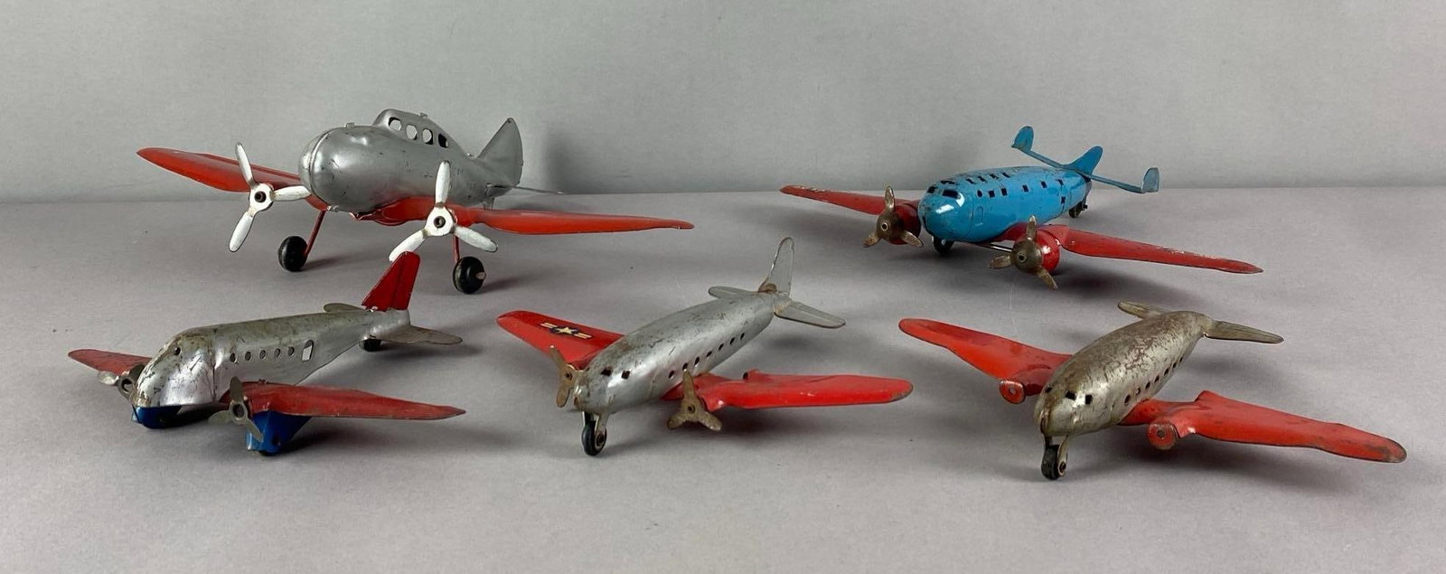 Group of 6 Vintage Pressed Steel Airplane Toys: includes 1 wyandotte marked airplane, largest measures 4 1/2 inches H x 16 inches W x 10 inches D