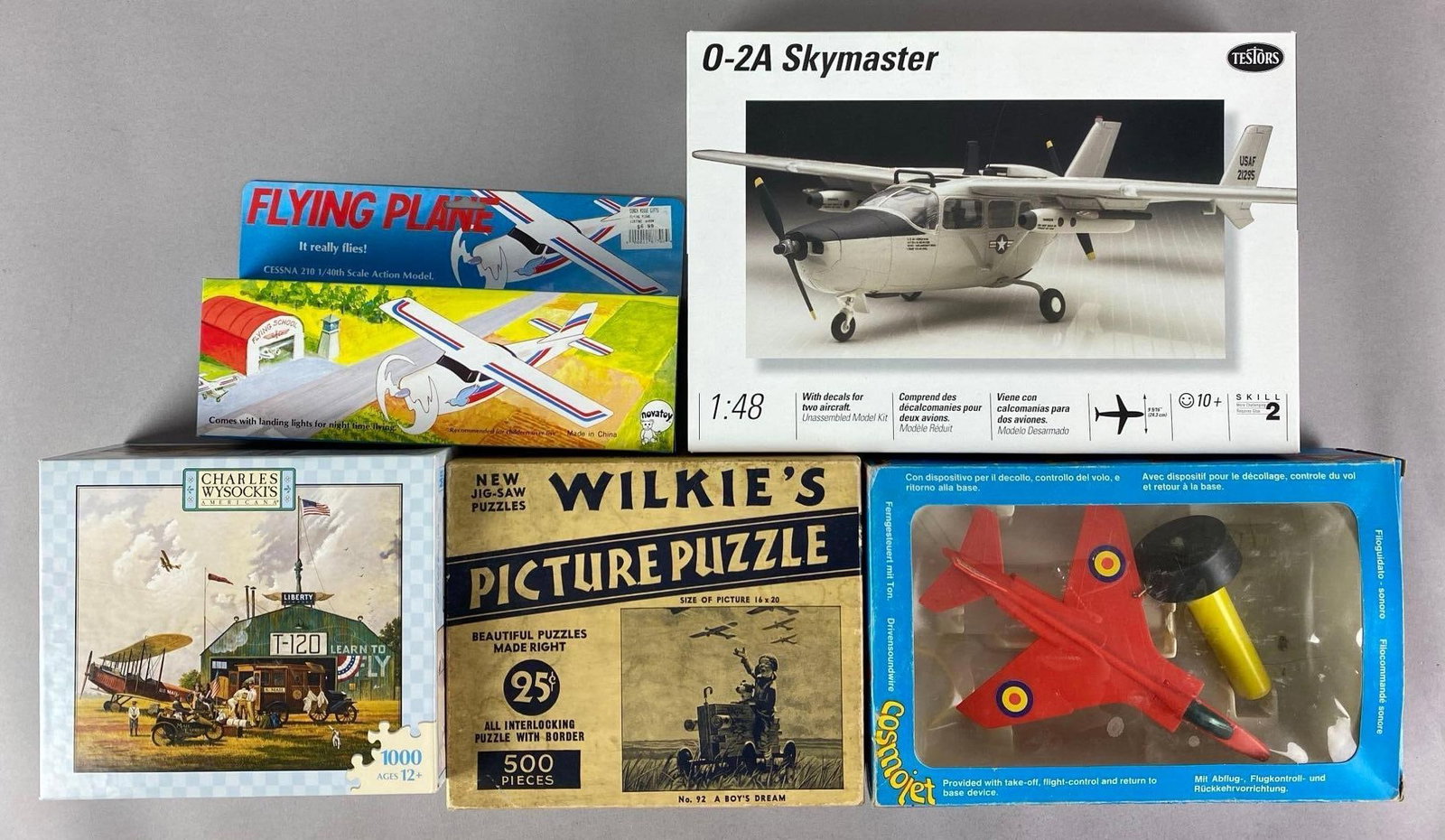 Group of 5 Assorted Aircraft Items: Includes puzzles, plastic model kit, battery operated flying plane and more, plastic model is 1/48 scale
