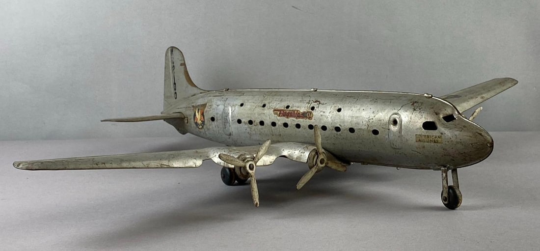 Antique 1940s Marx Toys Pressed Steel Douglas Dc-4 Airplane: Measures 21 inches in length. Wingspans 27 inches
