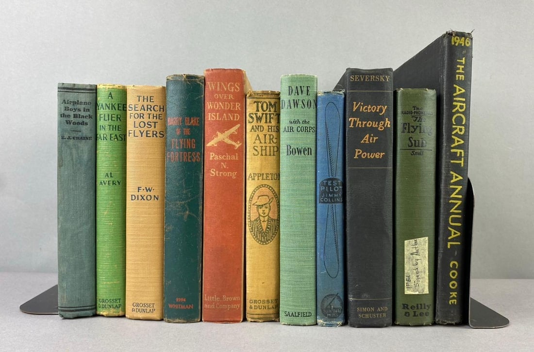 Group of Assorted Aviators Themed Books: Includes The Flying Sub first Edtion signed by Reilly and Lee, Dave Dawson, and more. Largest measures L 7 x W 5 inches. Bookends not included.
