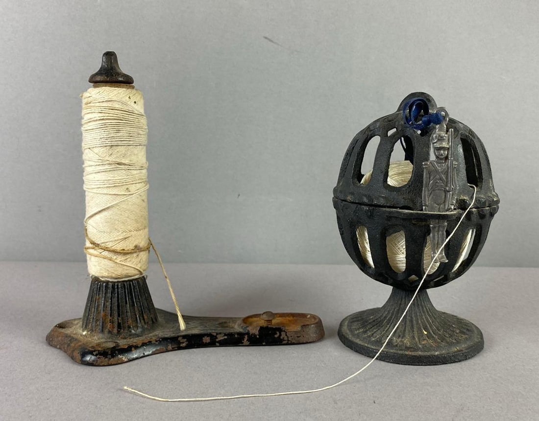 Group of 2 Antique Cast Iron Twine Dispensers: Includes Bird cage style and straight one. Largest measure 6 inches in length.