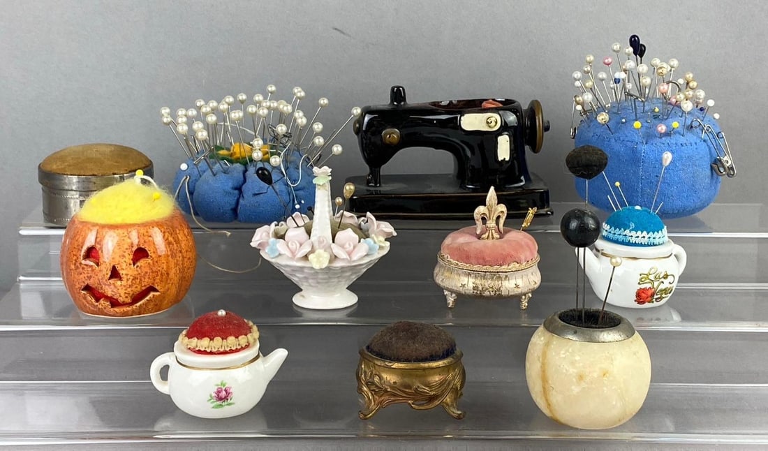 Group of Assorted Pin Cushion: Largest measures 5 inches in length. Stand not included.