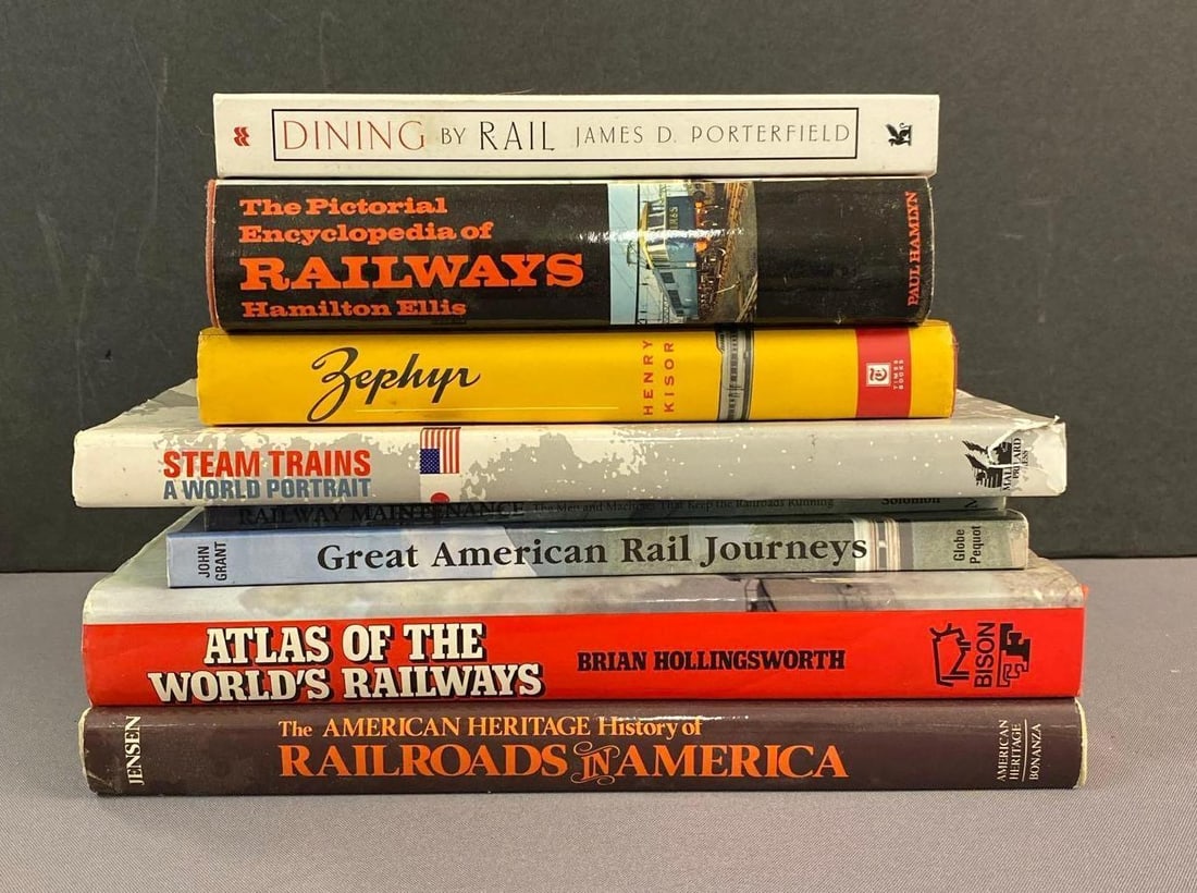 Group of 8 Locomotive Themed Books: Largest measures L 12 x W 10 inches.