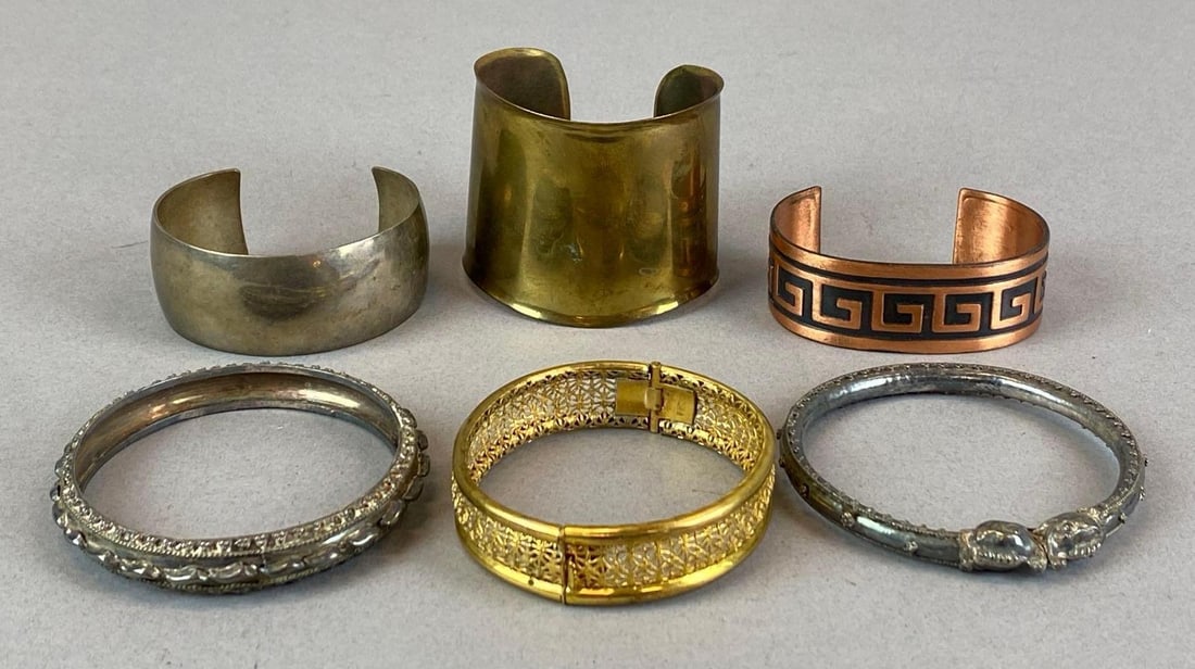 Group of 6 Costume Jewelry Bangles and Cuff Bracelets: Largest measures 2 inches H x 2 1/4 inches W with a inner circumference of 6 1/2 inches with a 1 inches opening