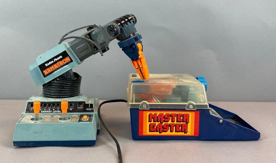 Group of 2 Vintage Childrens Manufacturing Toys: Untested, includes mattel master caster and radio shack Armatron, needs cleaning, largest measures 7 inches H x 6 1/2 inches W x 11 inches D