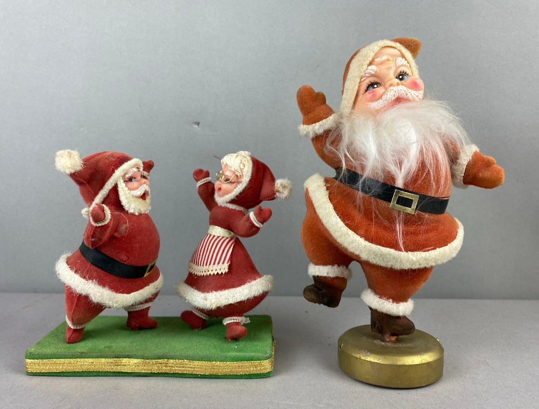 Group of 2 Vintage 1960s Blow Mold Flocked Santa Figures: Largest measures 9 inches tall.