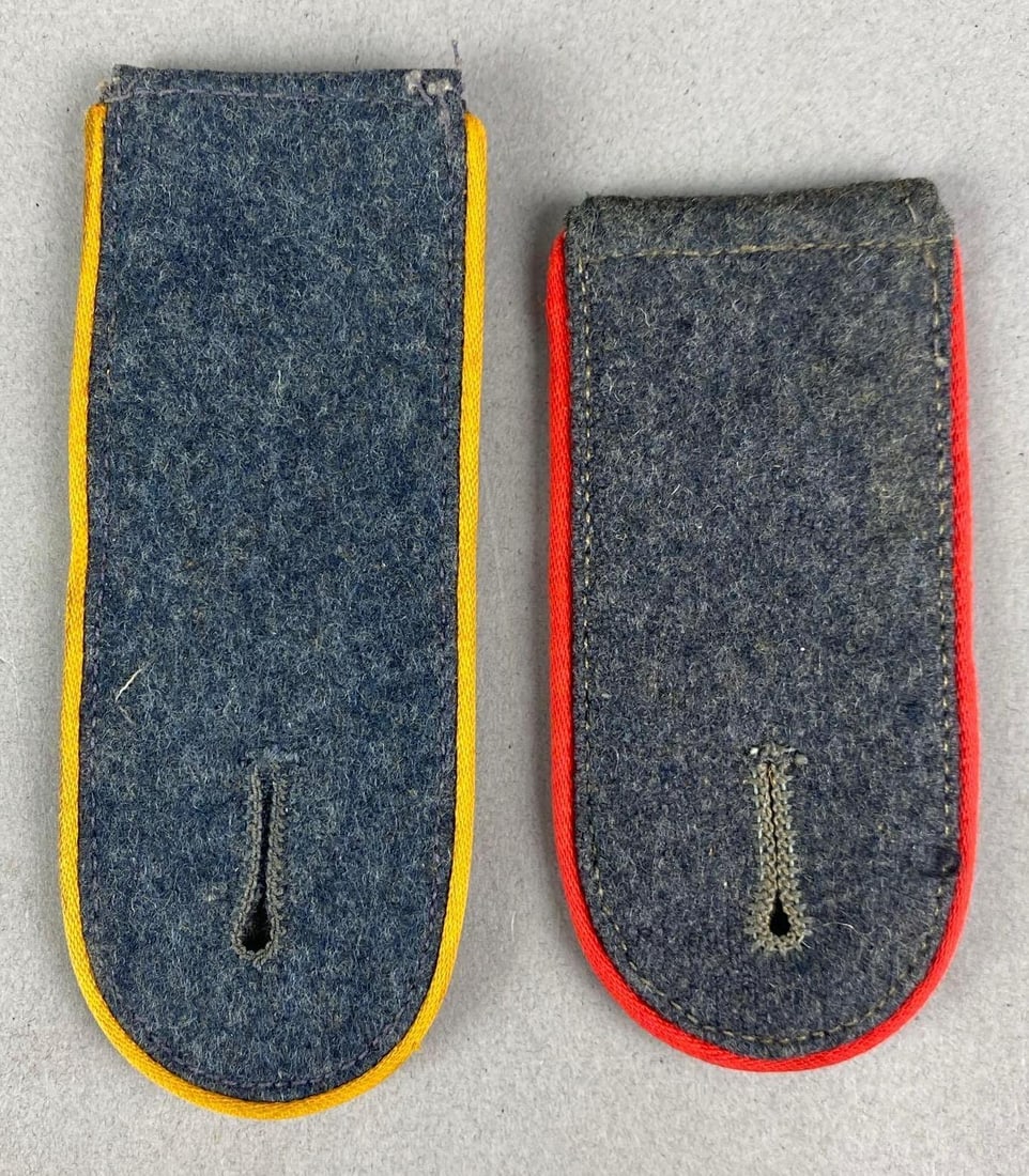 Group of 2 WW2 German Luftwaffe Shoulder Boards: Includes red piping Flak shoulder board and yellow piping NCO Flight shoulder board, largest measures 4 1/2 inches H x 1 3/4 inches W