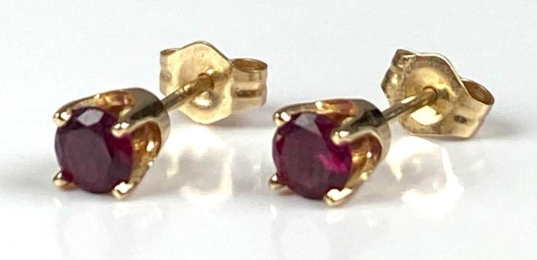 Pair of 14K Yellow Gold Ruby Stud Earrings: Total weight of 0.9 grams, each measures 1/2 inches in length