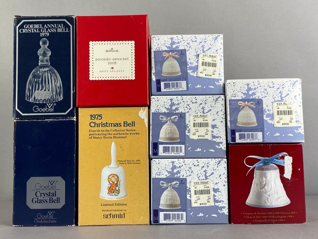 Group of 9 Bells: Includes goebel crystal bell, schmid Porcelain Christmas bell, Lladro porcelain bells and more, in original boxes, largest box measures 7 inches H x 4 1/2 inches W x 4 1/2 inches D