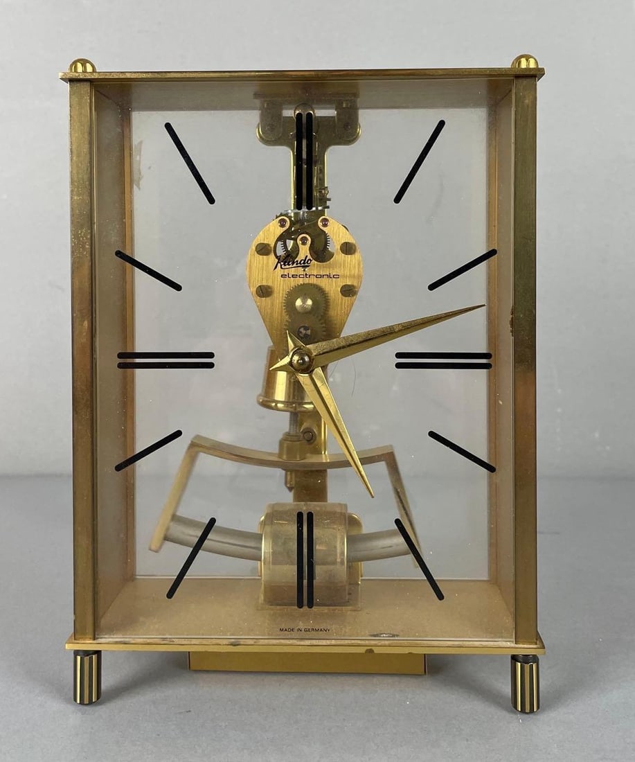 Vintage Kieninger & Obergfell Kundo Electronic Impulse Skeleton Clock: Battery operated, working condition, missing battery cover, measures 7 1/2 inches x 5 1/2 inches x 2 1/4 inches