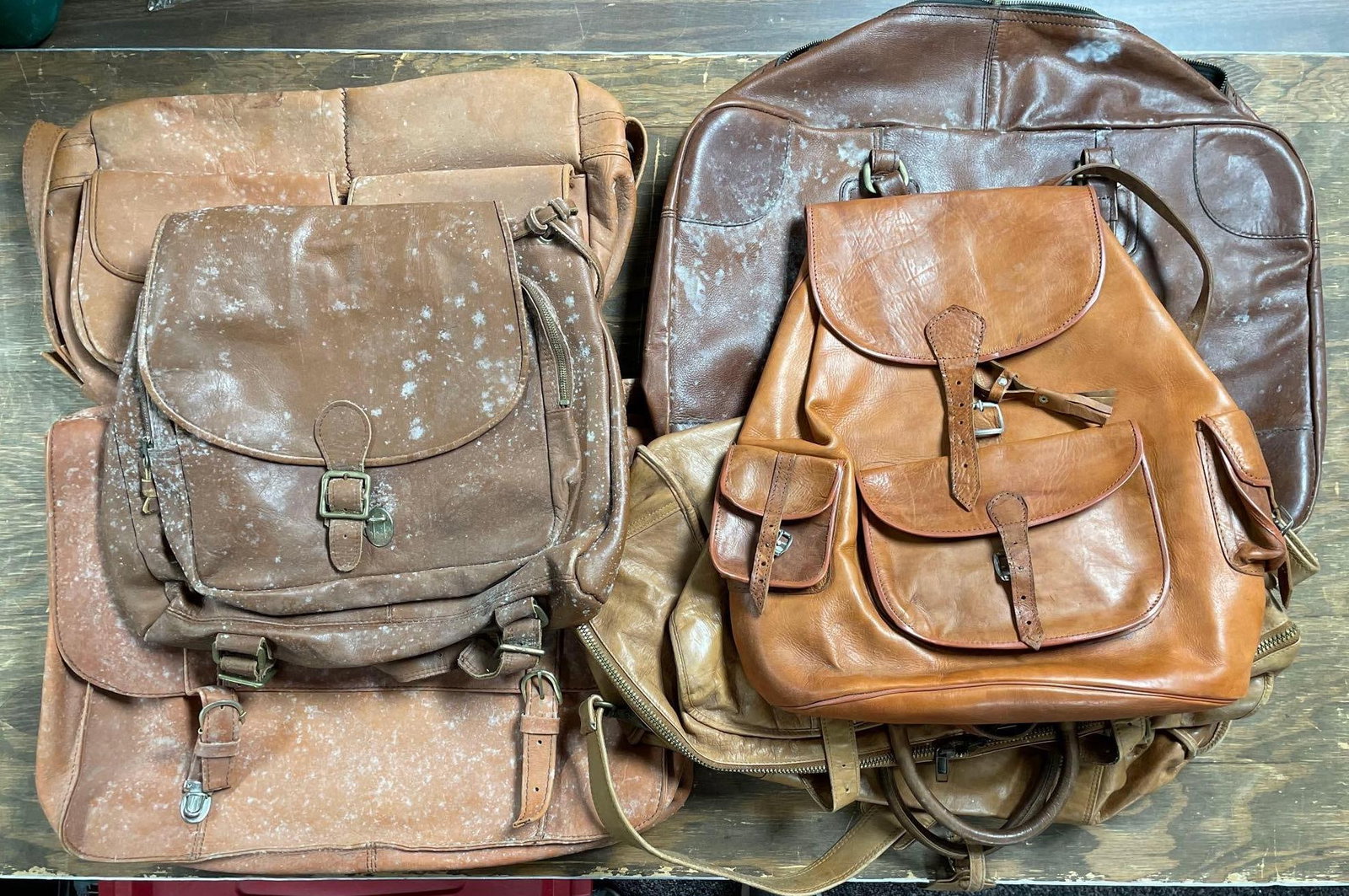 Group of Vintage Leather Bags: Includes backpacks, Dakota duffle bag, largest measures 15 inches x 22 inches x 5 inches