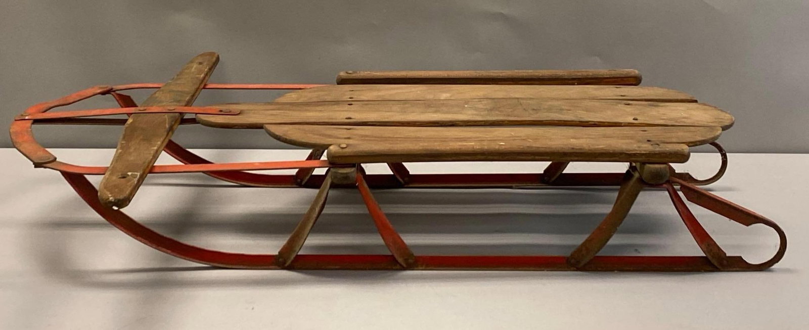 Vintage Royal Racer Wood and Metal Snow Sled: Paint wear and rust throughout, Measures 6 1/2 inches H x 22 1/2 inches W x 38 inches D