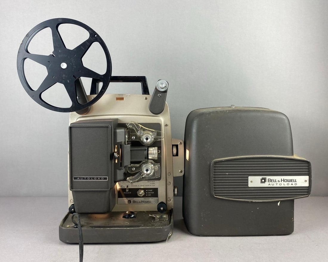 Vintage Bell And Howell Autoload Super 8 Film Projector: Unit powers on. Measures H 12 x W 7 x L 8 inches.