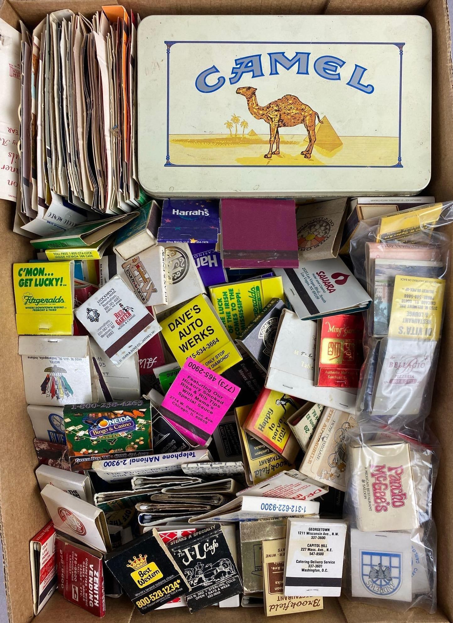 Group of 50+ Vintage Paper Advertising Matchsticks: Includes Camel, Harrahs, and more. Largest measures H 2 x W 4 x L 7 inches.