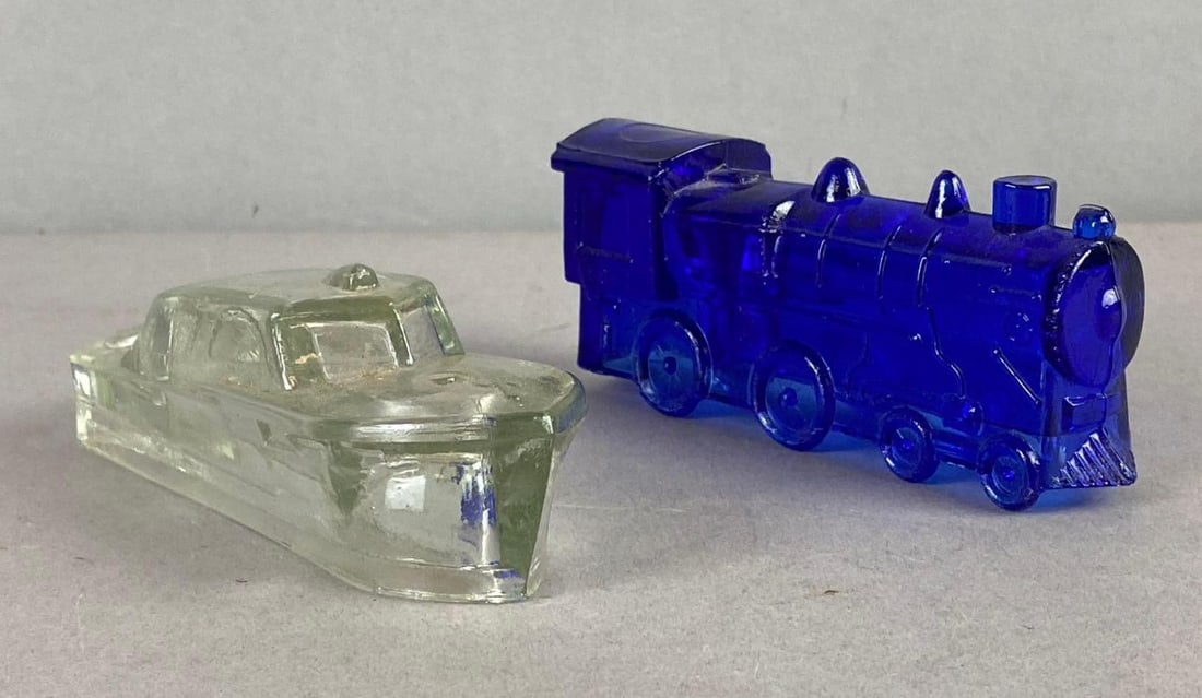 Group of 2 Boyd Glass Candy Figures: Includes locomotive and boat. Largest measures 4 inches in length.
