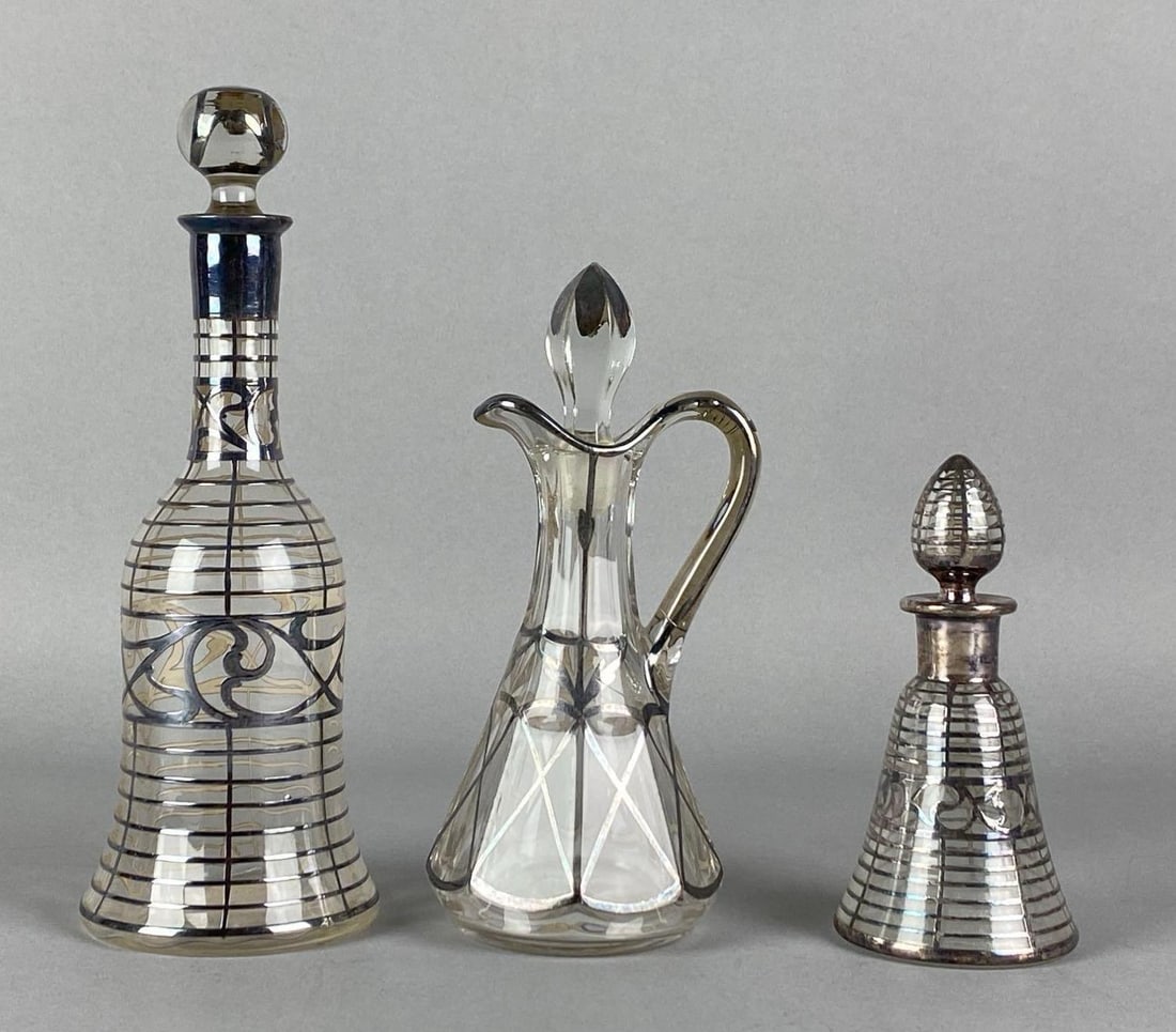 Group of Antique Silver Overlay Clear Glass Cruets: Tallest is marked sterling, Tallest has chipped stopper, Tallest measures 8 1/4 inches H x 3 inches W x 3 inches D