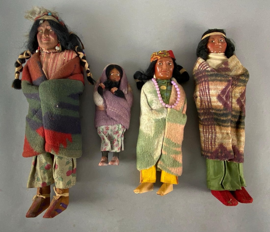 Group of 4 Skookum Native American Dolls: Some small chips on face of one, Tallest measures 14 inches tall.