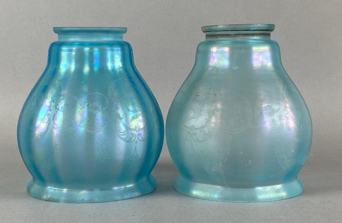 Group of 2 Antique Frosted Cobalt Iridescent Glass Lamp Shades: Both features art nouveau motif of floral elements and female portrait silhouette, one chipped on rim, each measures 5 inches H x 4 1/4 inches W with a 2 1/4 inches fittee