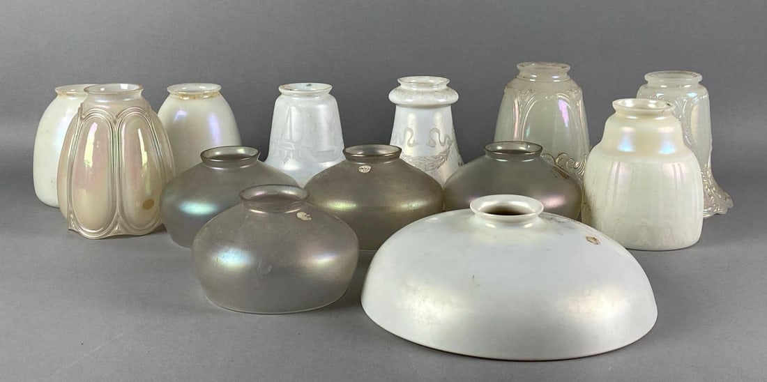 Group of Antique Satin Glass Lamp Shades: Most are iridescent, features etched laurels, floral motifs and more, largest measures 3 inches H x 8 1/2 inches W with a 2 inches fitter