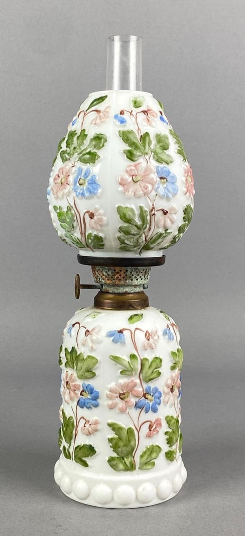 Vintage Floral Motif White Glass Oil Lamp: Some corrosion shown on brass hardware, Measures 9 3/4 H x 3 W x 3 D