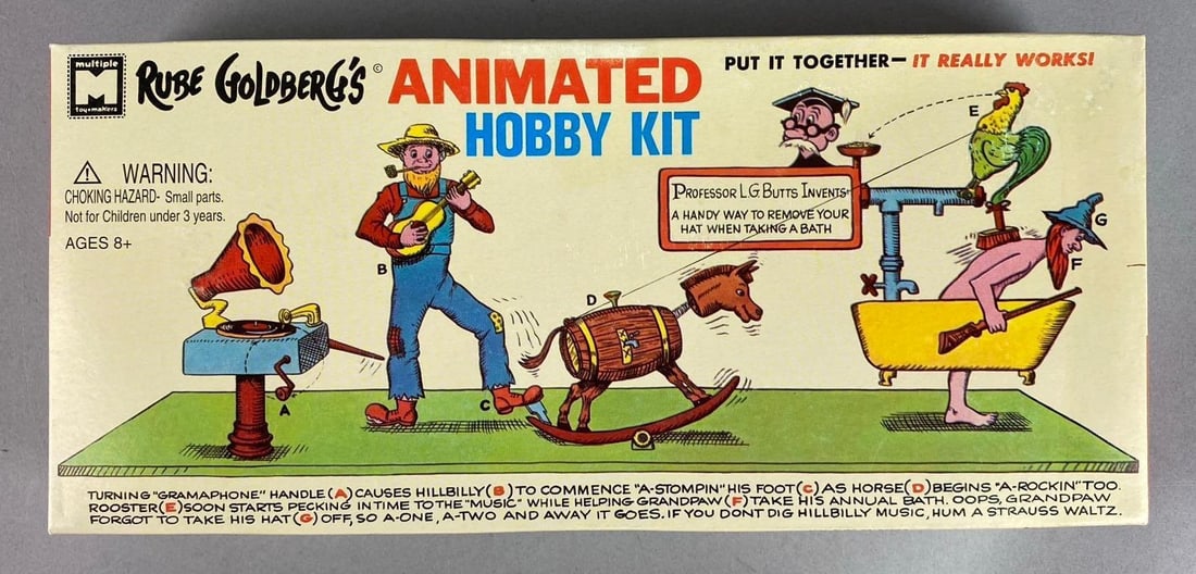 1965 Rube Goldberg?s Animated Back Scrubber and Hat Remover Kit: Open Box. Complete. Measure H 2 x W 5 1/2 x L 12 inches.