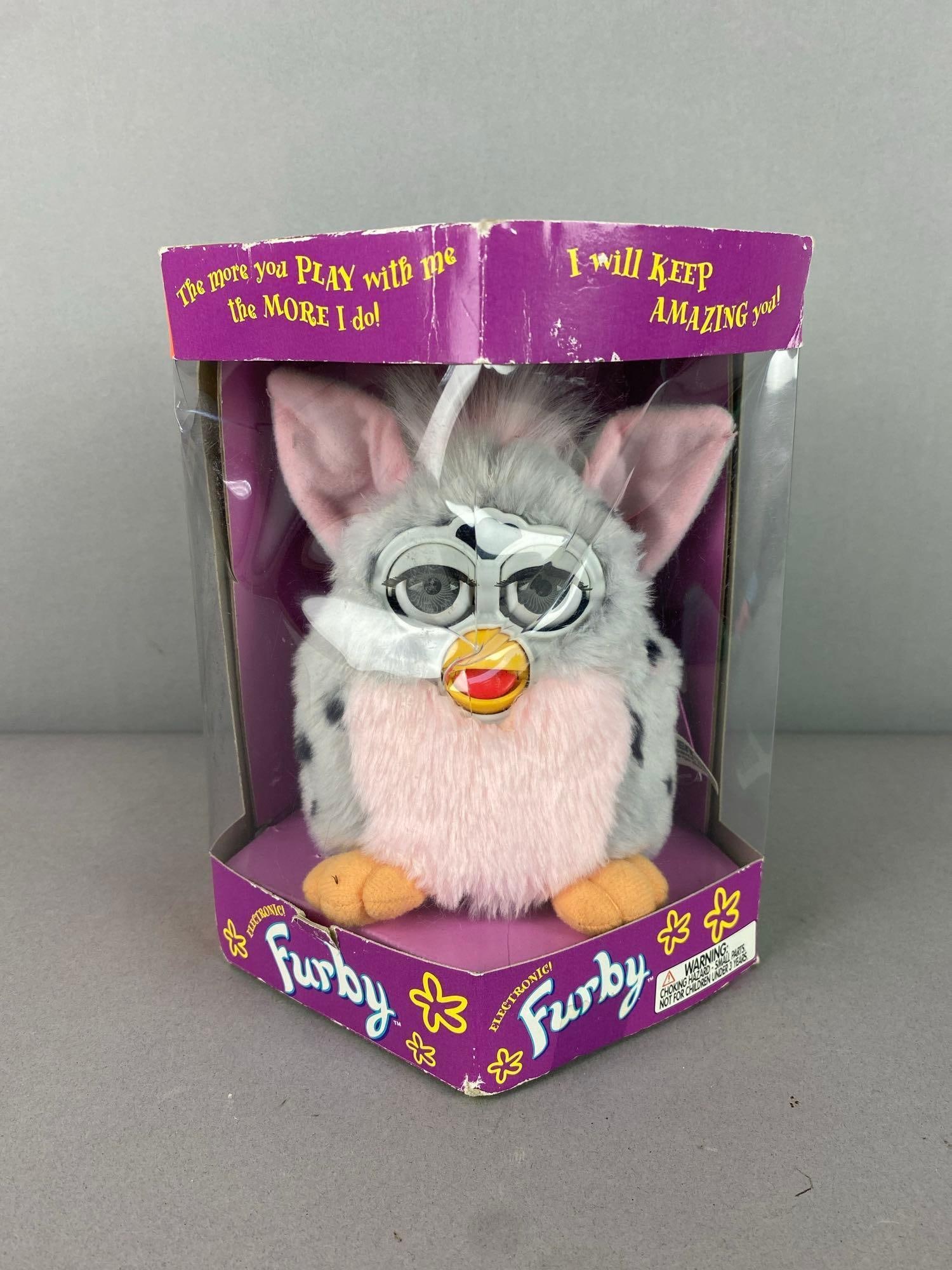 1998 Tiger Electronics Furby Animatronic Figure: Like new in original packaging. Measures 8 tall. Packaging has rips and tears throughout.