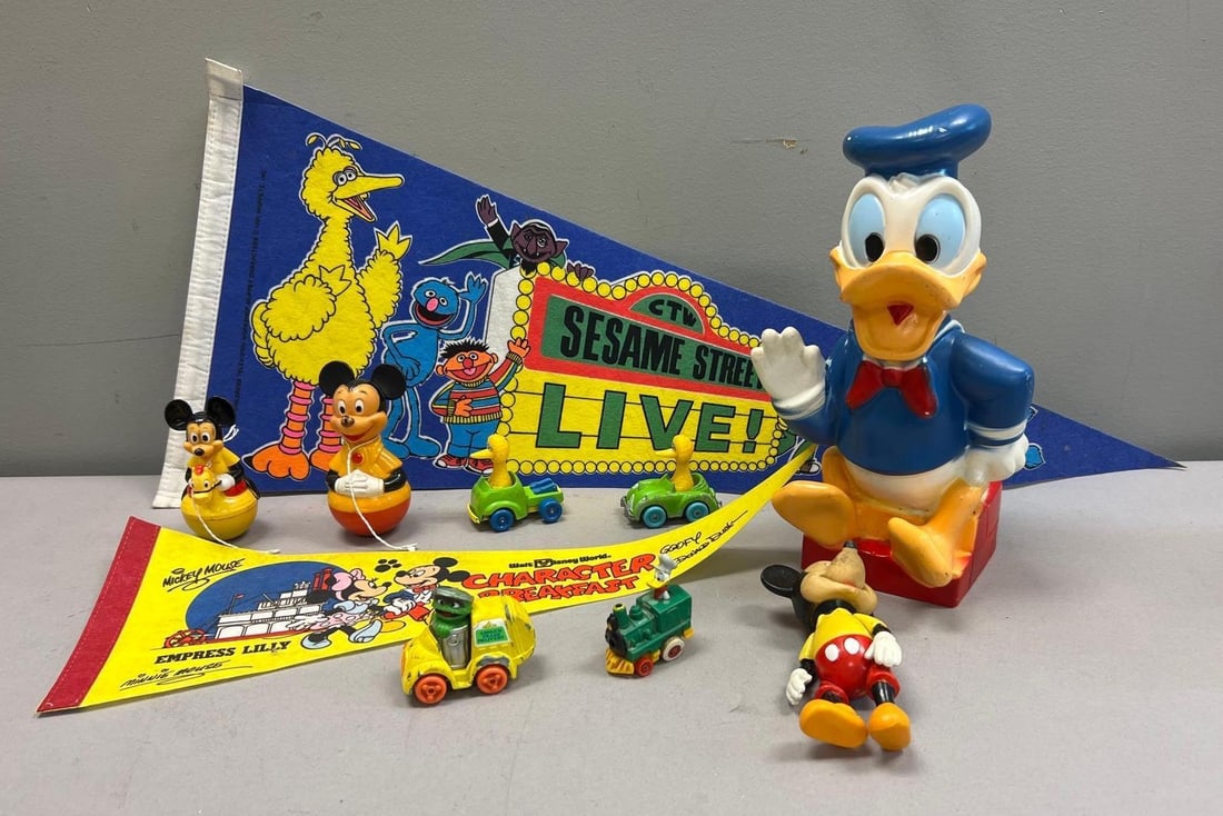 Vintage Disney, Sesame Street and Character Toy Assortment with Pennants and Donald Duck Bank: Donald Duck bank measures 6 inches W by 6 inches D by 11 inches H