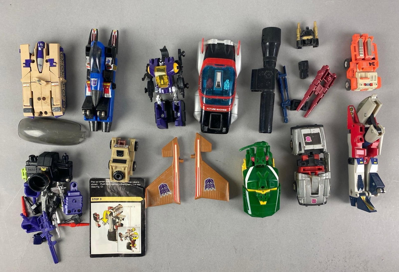 Group of 1980s Hasbro Transformers Action Figures and More: Includes Accessories, manual, Marx transforming toy and more, largest measures 5 H x 2 1/2 W