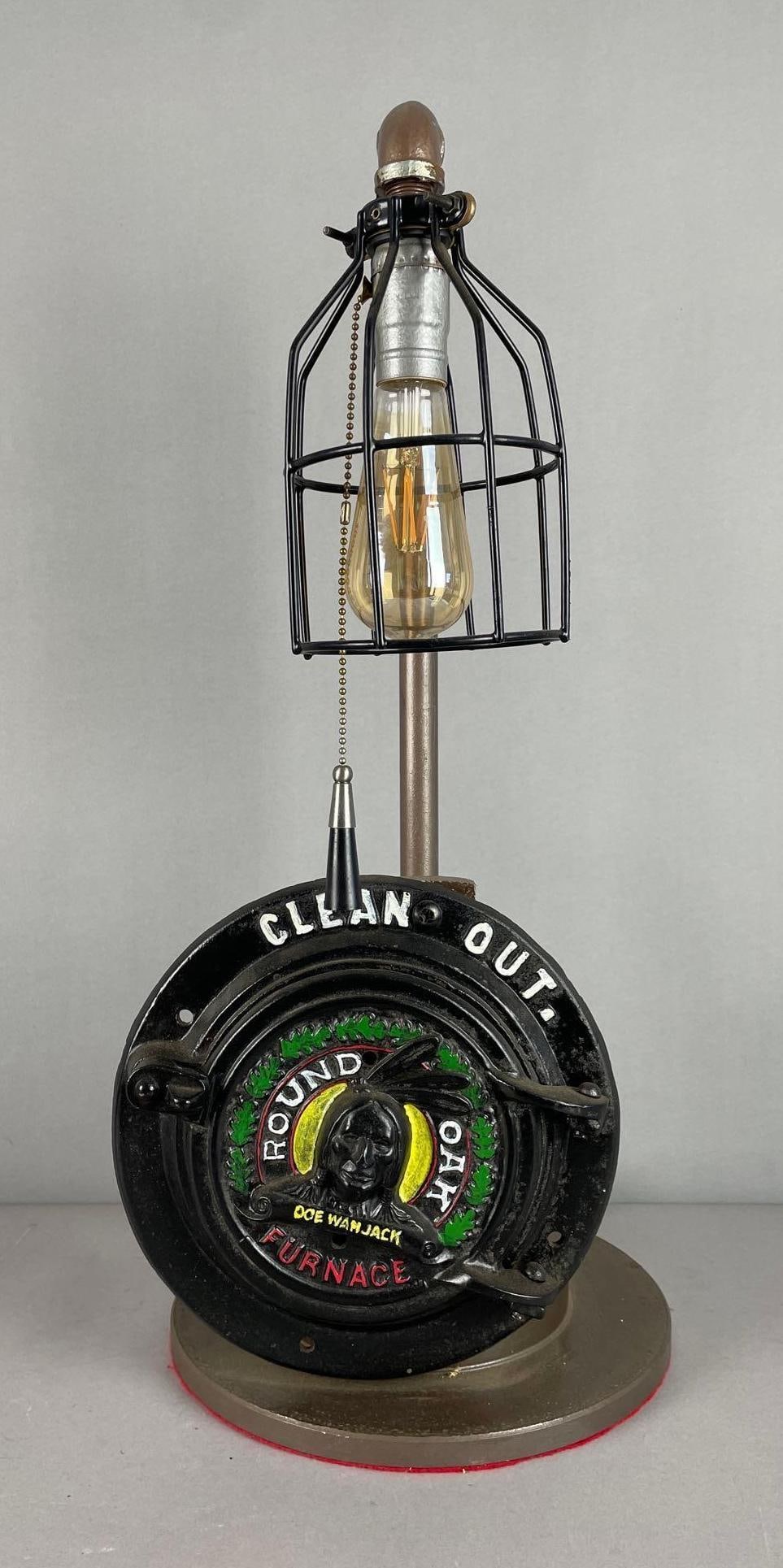 Custom Industrial Round Oak Furnace Clean Out Table Lamp: Working condition, measures 24 inches, 10 1/2 inches base