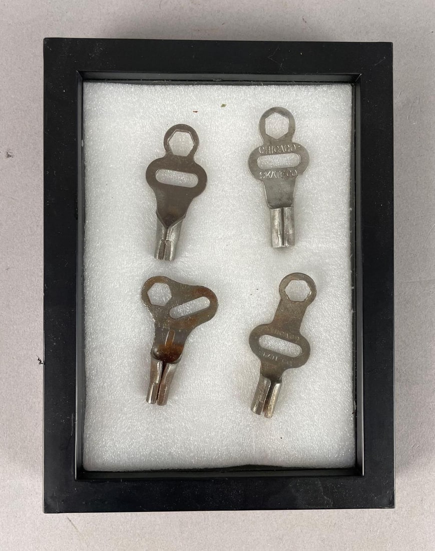 Group of 4 Vintage Chicago Skate Co. Roller Skate Keys: Display frame measures 8 inches x 6 inches