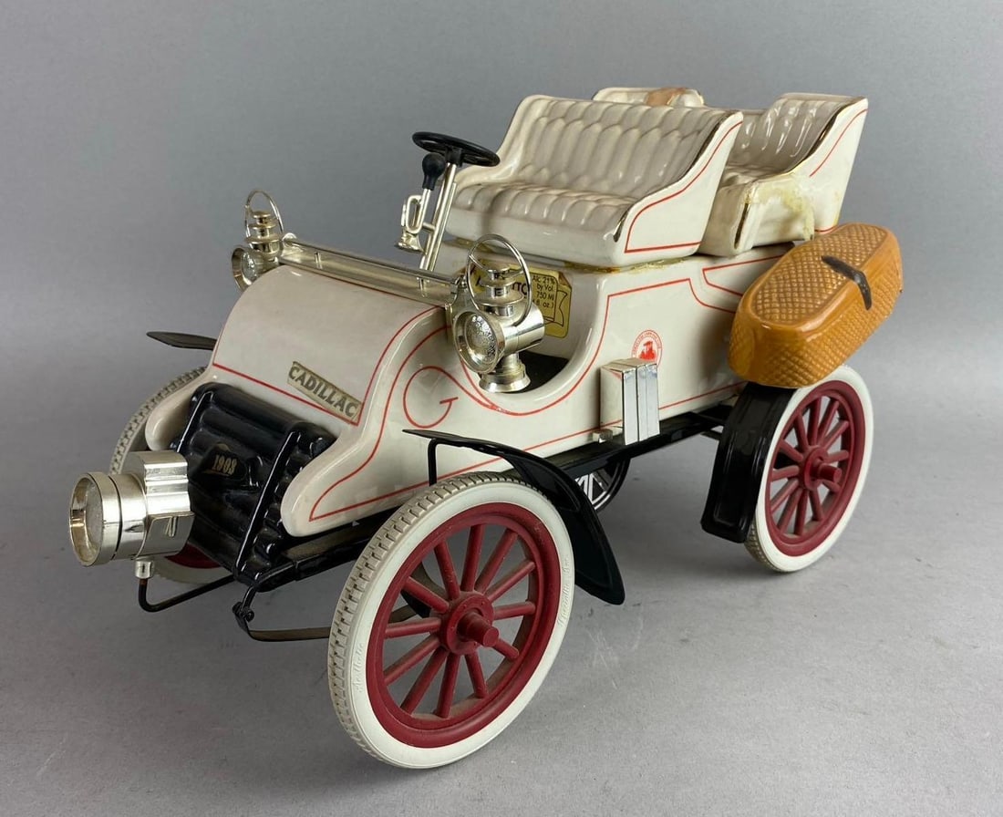 Vintage 1970s ASI 1903 Cadillac Car Ceramic Decanter: one saddle bag has fallen off. Car measures 13 inches in length.