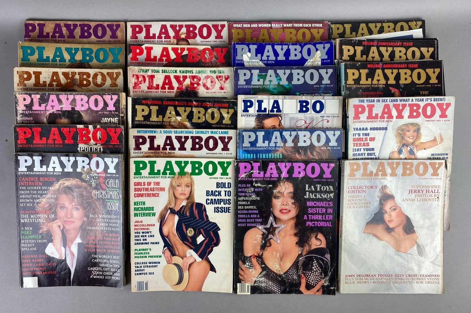 Group of 20+ Vintage 1980s Playboy Magazines: Includes Oct 1985, March 1989, and more. Rips and tears throughout. One measures L 11 x W 8 inches.
