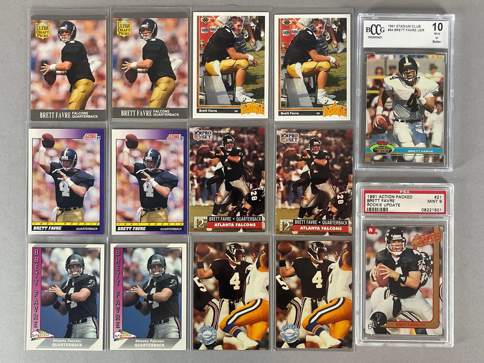 14 - 1991 Brett Favre Rookies with 2 - Graded: 1991 Action Packed Brett Favre Rookie Update #21 PSA 9, 1991 Stadium Club Brett Favre Error #94 BCCG 10, 2 of each other brands