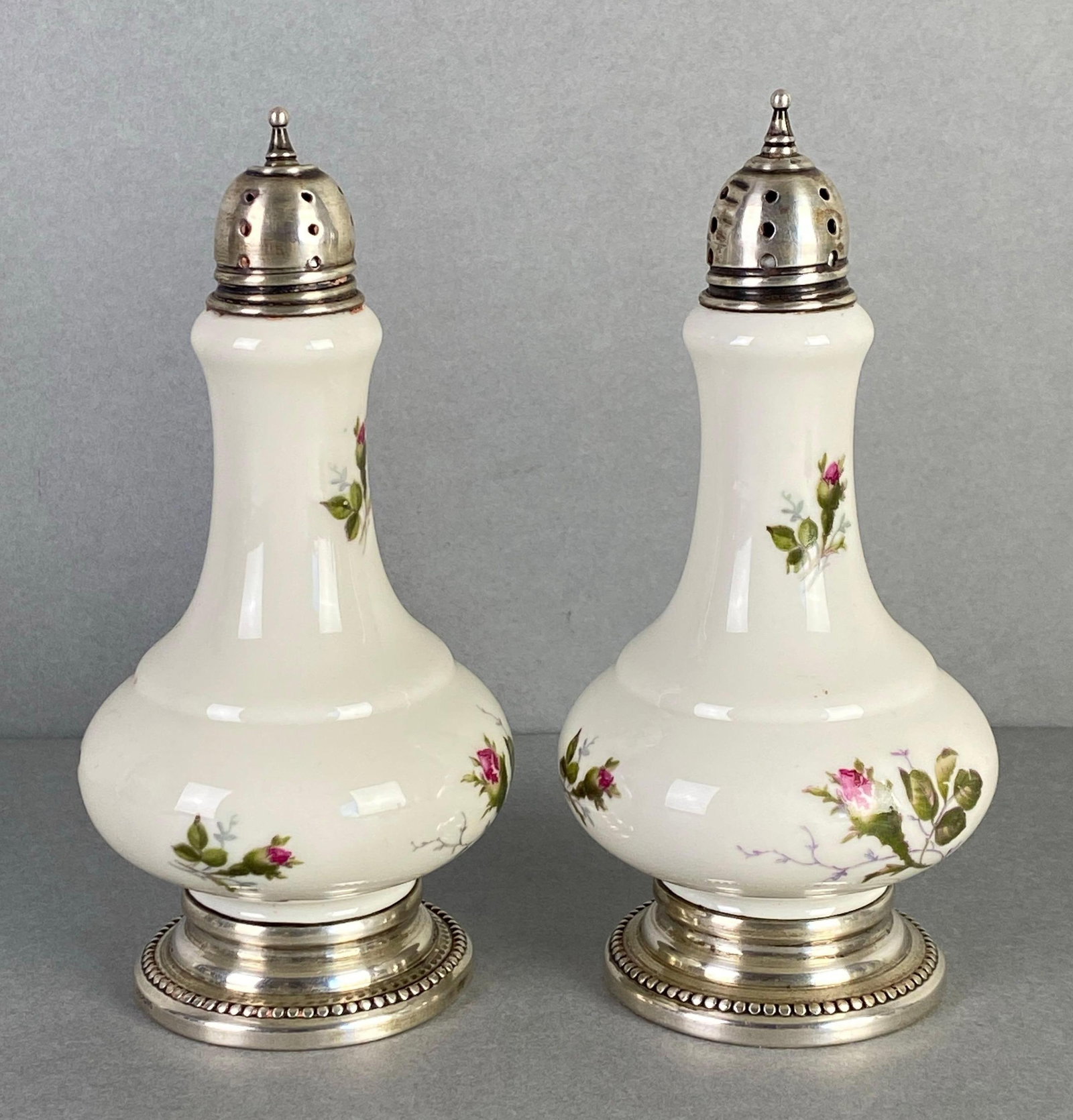 Pair of Rosenthal Floral Porcelain Salt and Pepper Shakers: Made in Germany, Sterling silver base and Caps, marked on base, each measures 5 x 2 1/2 inches