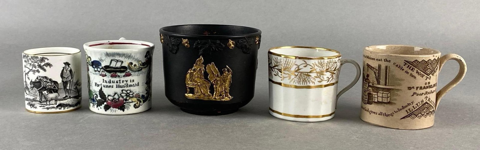 Group of 5 Porcelain Mugs and More: Includes transferware, Frugality and Co., Cameo, and more, Some chips and cracks, One missing handle, Largest Meashres 3 1/4 x 5 x 4 inches.