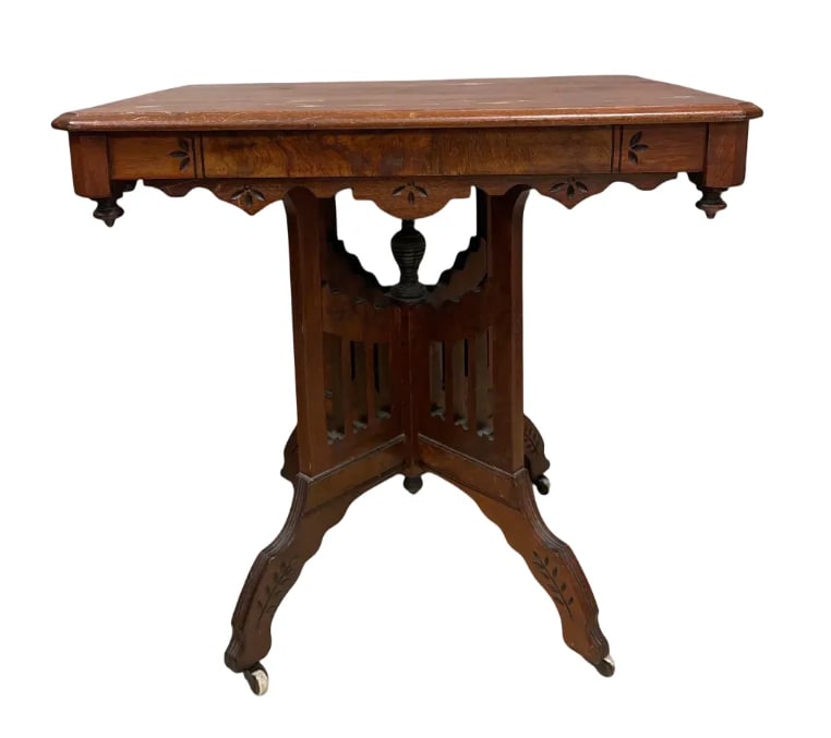Antique Victorian Walnut Parlor Table: No in-house shipping available, 3rd party shipper or pickup. Carved leaf and flowers, top has water stains, cracked joint, castors, measures 29 inches x 30 inches x 22 inches