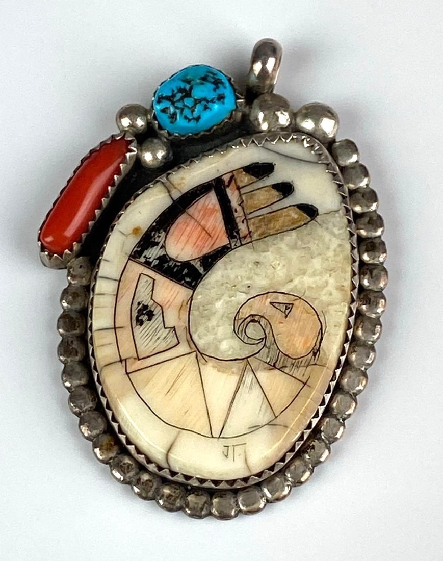 SK Emerson Sterling Silver Native American Pendant: Features turquoise, coral and a figural motif on antler, Measures 1 3/4 inches H x 1 inches W