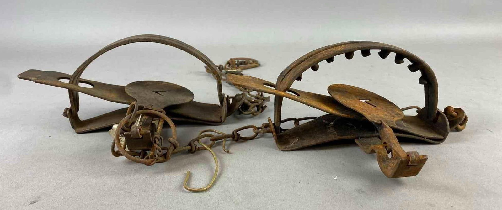 Group of 2 Antique Oneida Victor Coil/ Long Spring Animal Traps: Tested and working. Rust throughout. One measures 6 inches in diameter.