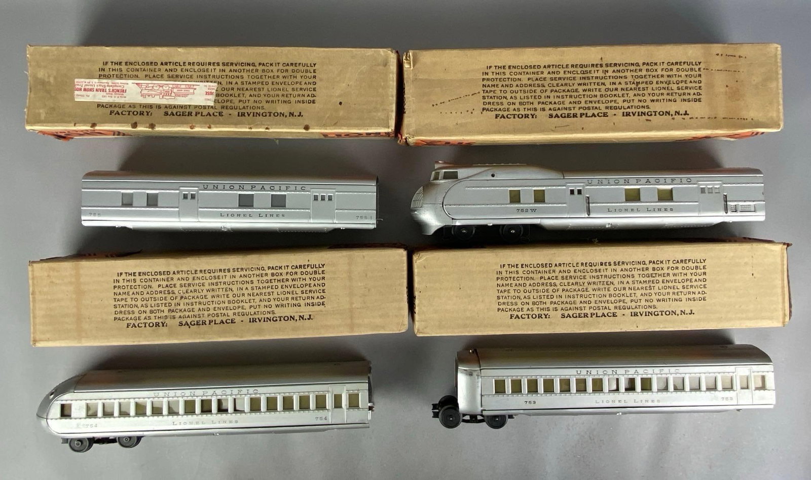 Set of 4 Lionel O Scale Union Pacific Locomotive and Passenger Cars: Untested, with original boxes, includes , locomotive measures 16 inches in length