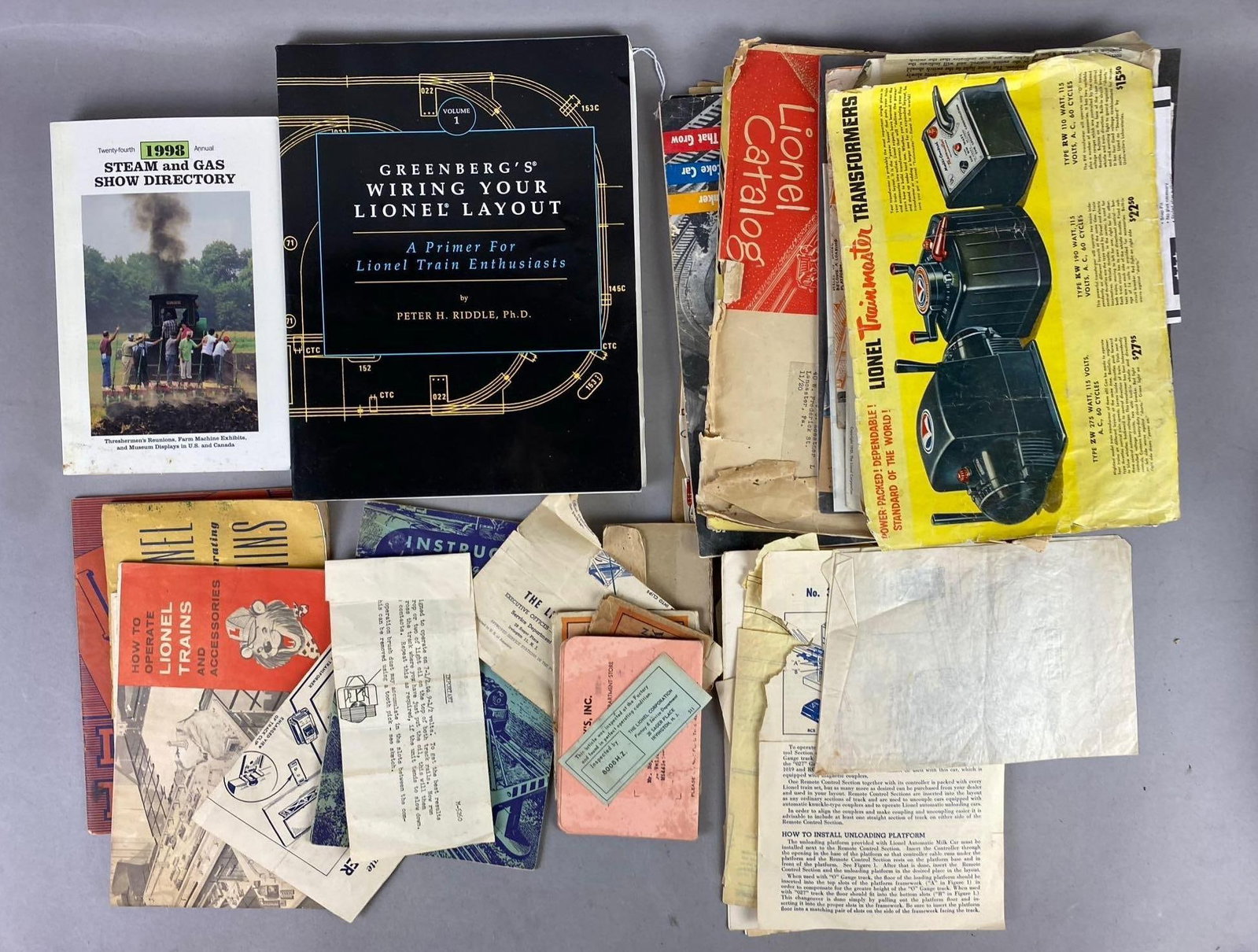 Group of Assorted Vintage 1950s Lionel Trains Instructions and More: Includes Greenberg book, catalogs, and more. Rips and tears. Largest measures L 11 x W 8 inches.