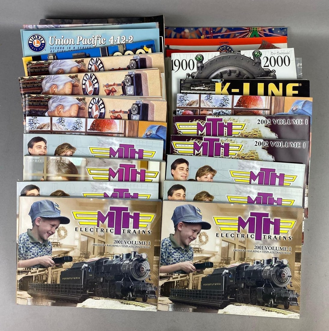Group of 30+ MTH Electric Trains Magazines and More: Circa 2000s. One measures L 10 x W 8 inches.