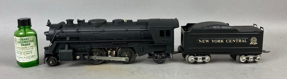 1950s Marx No. 666SM O Gauge Smoking Steam Locomotive: NOS. New in original packaging. Includes original smoking oil. Untested. Packaging measures H 4 x W 6 x L 10 1/2 inches.