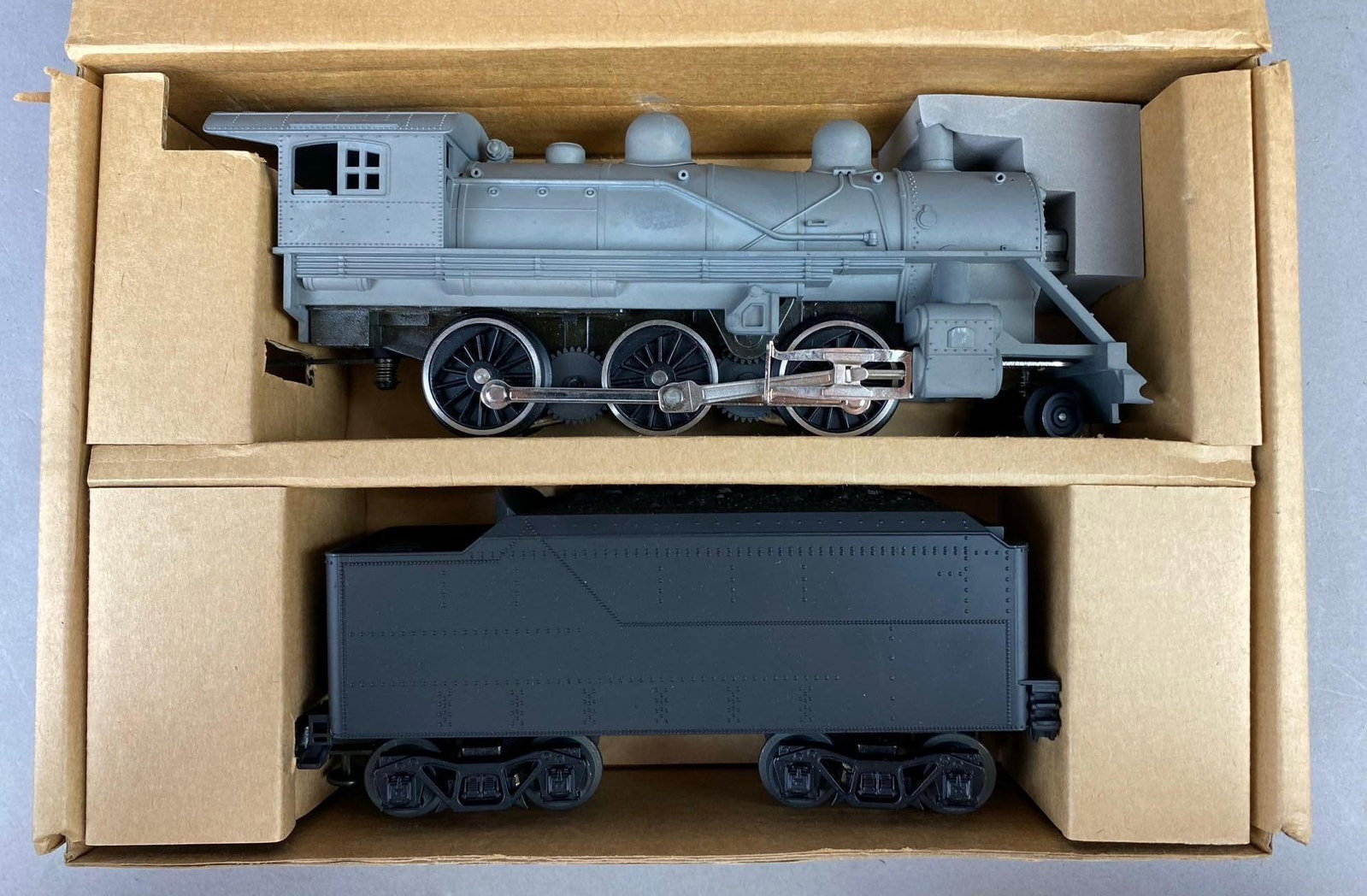 MTH Electric Trains Unpainted O Gauge Steam Locomotive Set: New in its original packaging. Comes with hardware. Locomotive measures 9 inches long.