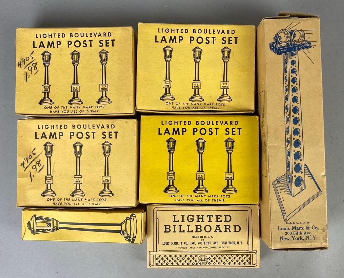 Group of 7 1950s Marx Lighted Boulevard Lamp Post Sets and More: Includes billboard and flood light tower. Largest measures 10 inches tall.