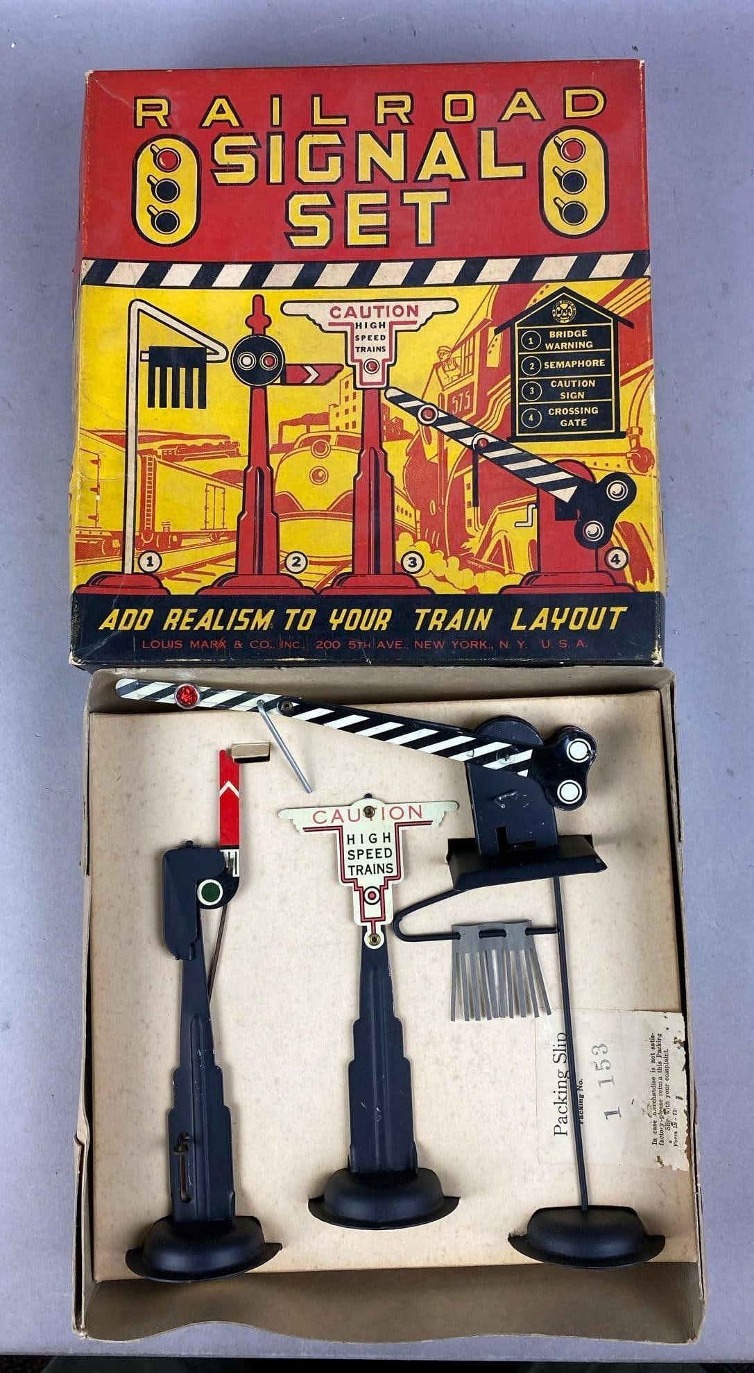 1950s Marx O Gauge Railroad Signal Set: Like new in original packaging. Measure H 3 x W 10 x L 11 inches.